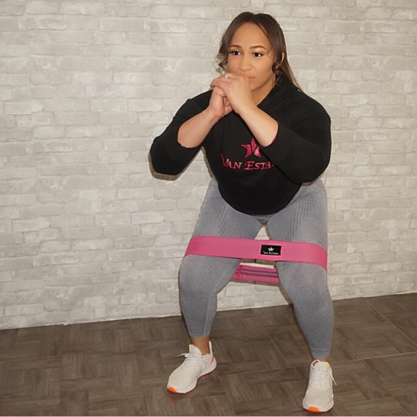 Woman working out using the Pink Van Esther Heavy Glute/ Booty Band